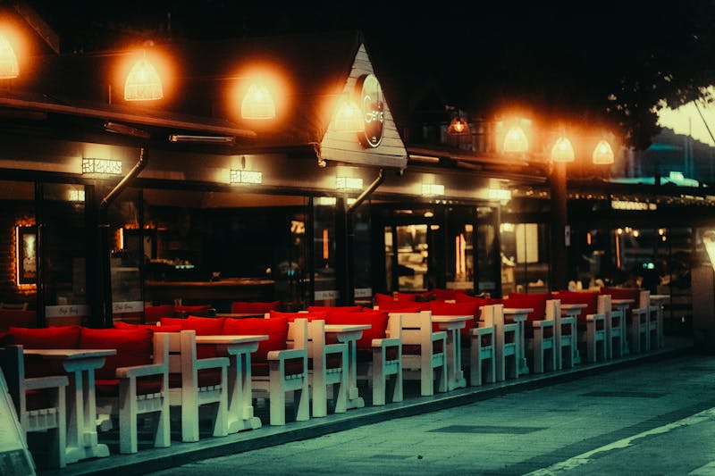 Round table pizza restaurant interior with warm lighting and communal seating