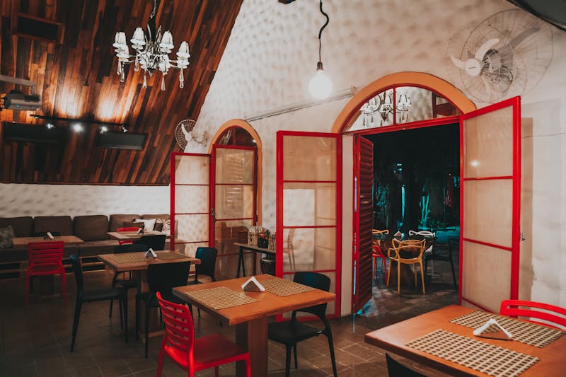 Round table pizza restaurant interior with warm lighting and cozy seating